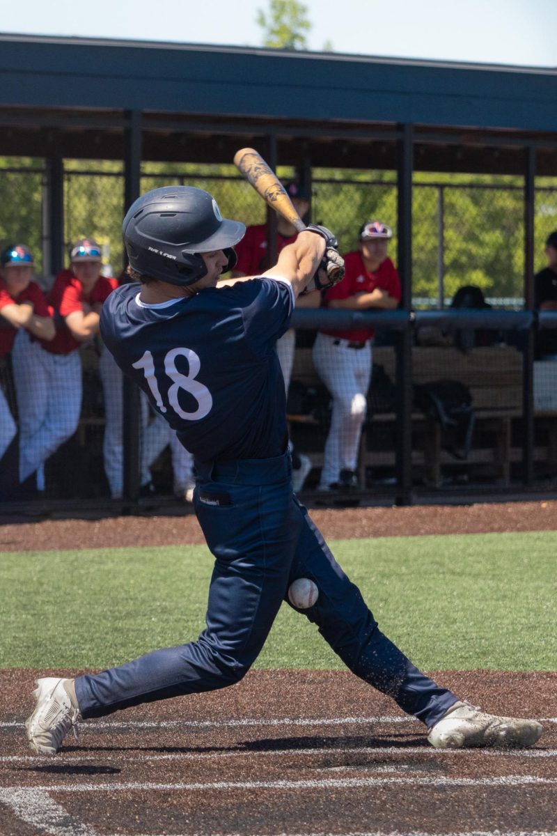 Turfs sprays into the air as Will Brown fouls off a pitch toward his feet on April 25. The ball went off the bottom of his bat, which caused it to go straight down instead of in the field of play. 