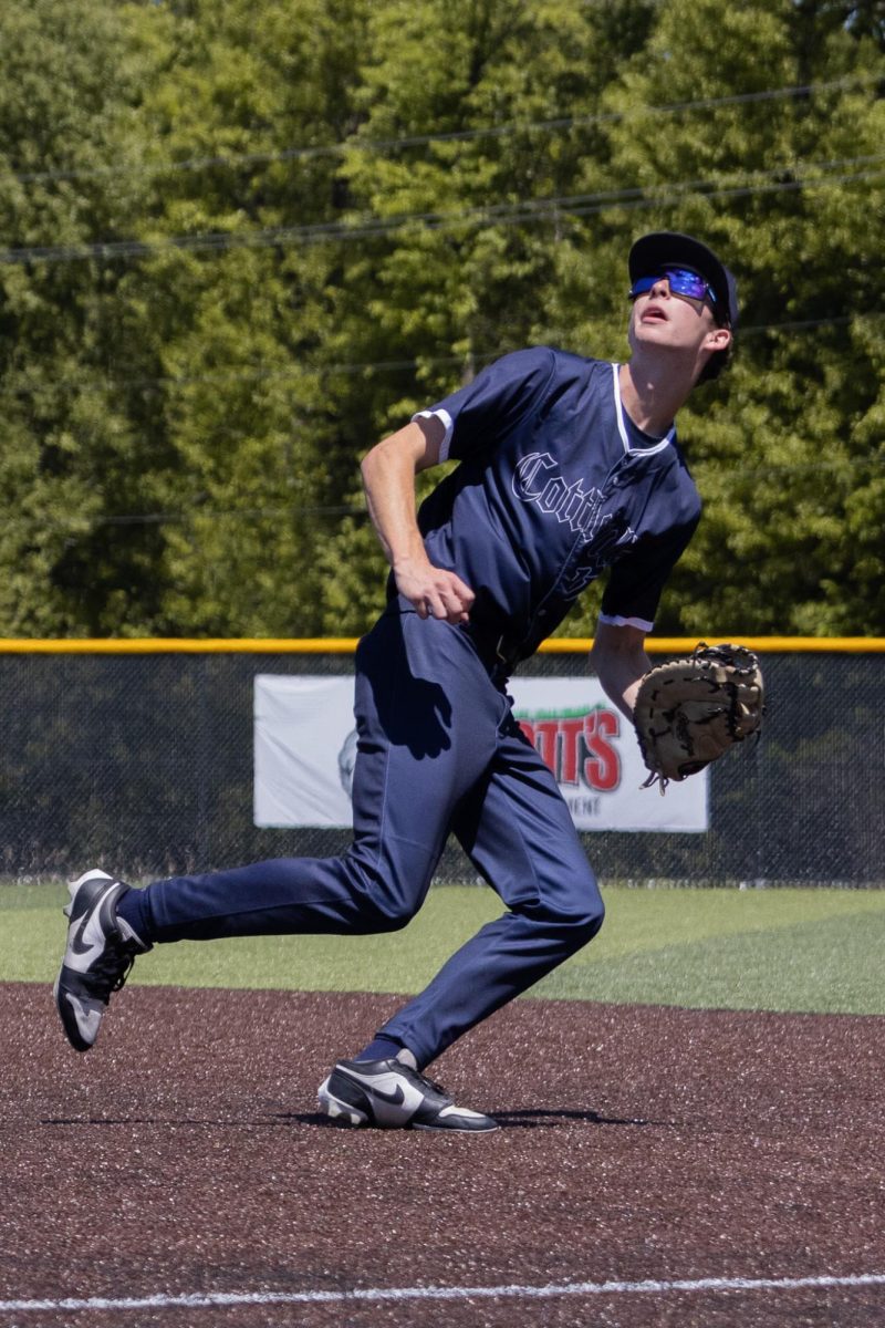 Running backwards toward the foul ball on April 25, junior Brody McAllister looks upward. Players often practice a drop step to get to a ball behind them faster.