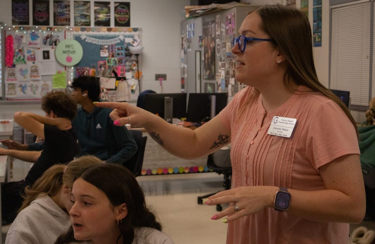 The students ask questions and Danielle Weber points to what they are asking. She is going around the classroom making sure everyone is on task and knows what they are doing on April 28.