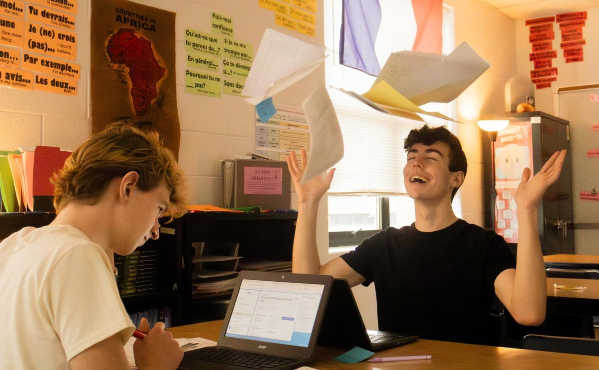 Lucas Ostermeyer, a sophomore, stresses over his future applications to college as senior Declan Fowler is relieved from his high school duties, tossing his papers into the air. Each of these students have worked vigorously through their schooling thus far, overcoming pressures of burnout along the way.