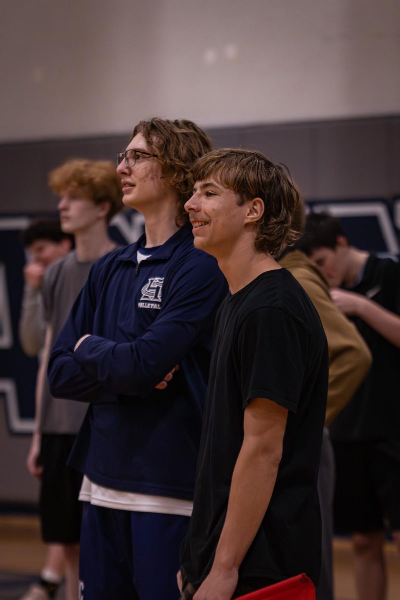 Observing Howell’s practice before the game on April. 21 sophomore Owen Barbeau and freshman Henry Barbeau share a small conversation off to the side. Owen played on the JV game that happened prior to varsity.