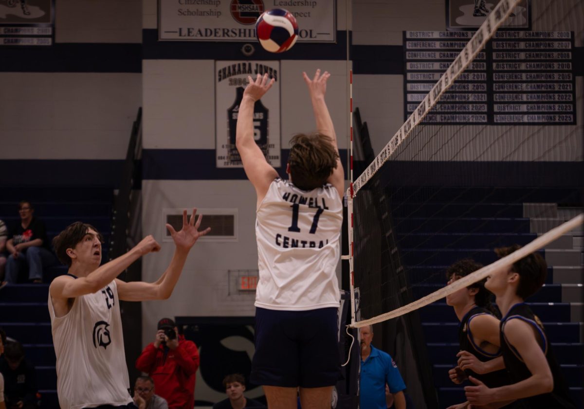 As the ball rises into the air, Josh Hadden signals to his teammate, junior Caleb Dolan, to get into position on April. 21. Dolan jumped into the air, smashing the ball to the other side.