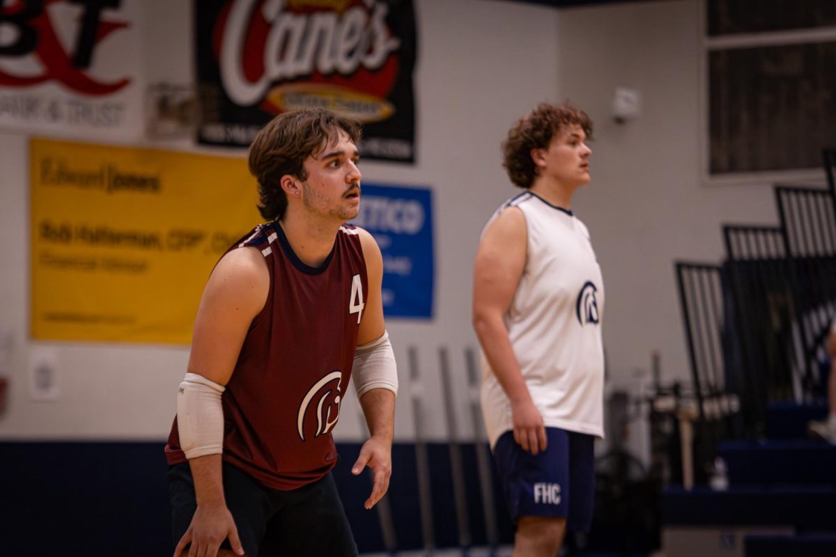 Preparing for Howell to serve, seniors Braden Harton and Trent Adkerson stay vigilant and watch for the ball on April. 21. Tension began to rise as the first half of the game came to an end.