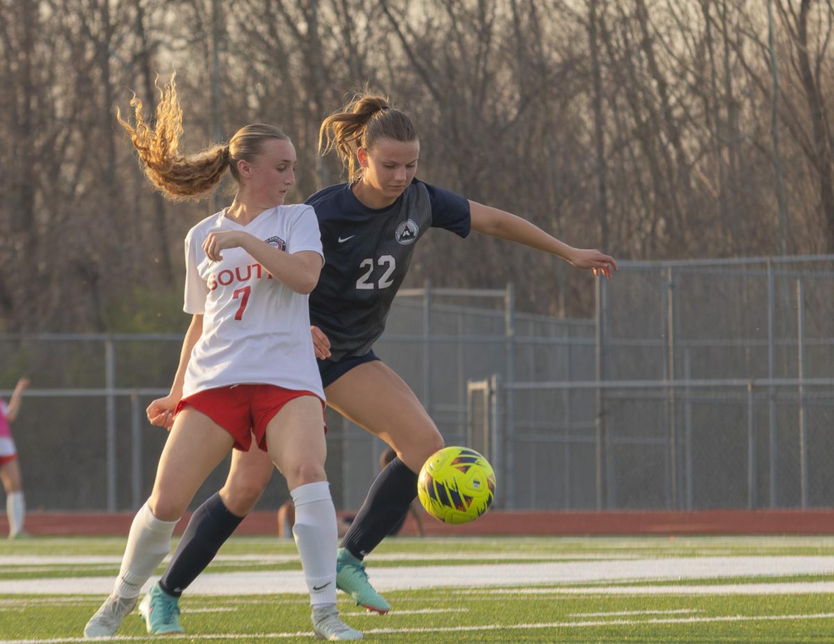  While going down the field, senior Olivia Osborn takes the ball from a south opponent and kicks it away. The ball was taken and passed in an attempt to make a goal on March 20.