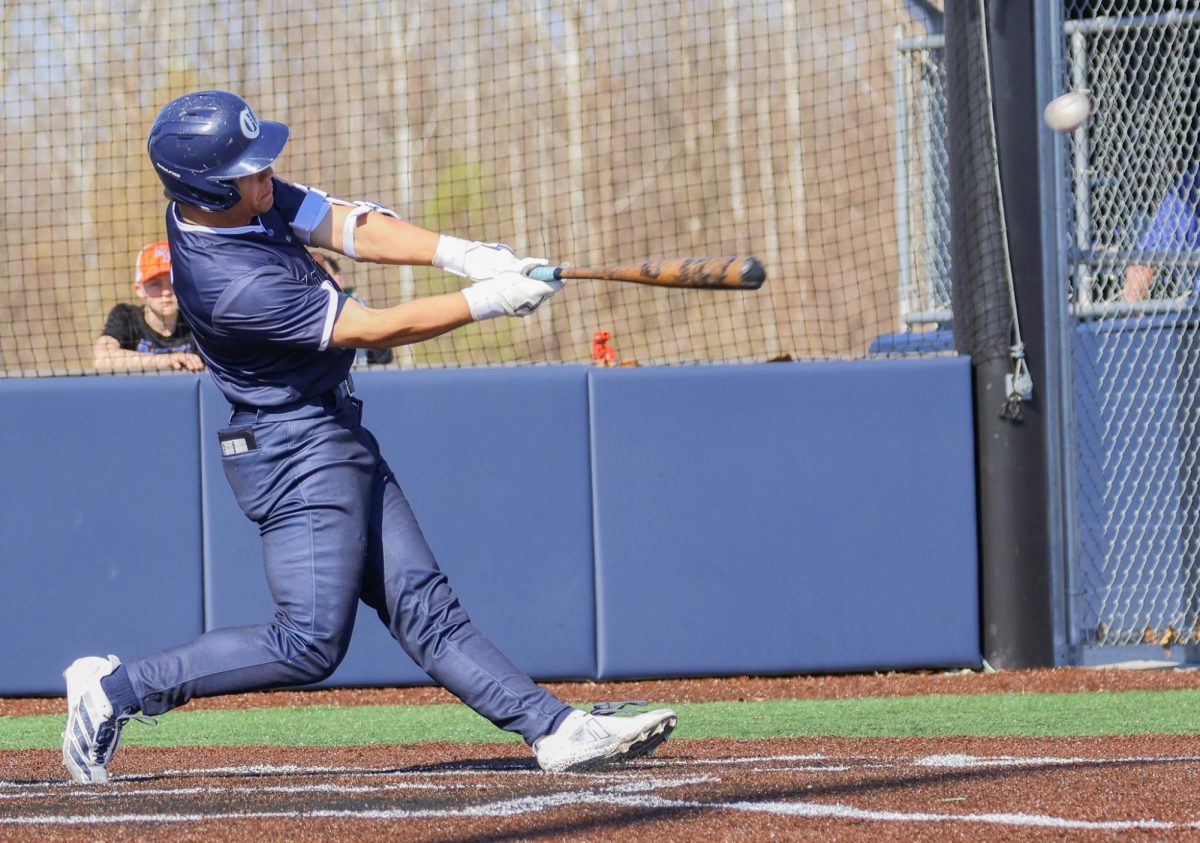 Senior Drew Wyss goes to extension after making contact with the ball. Wyss then runs to first base and keeps his eyes on the ball as he rounds the bag.  
