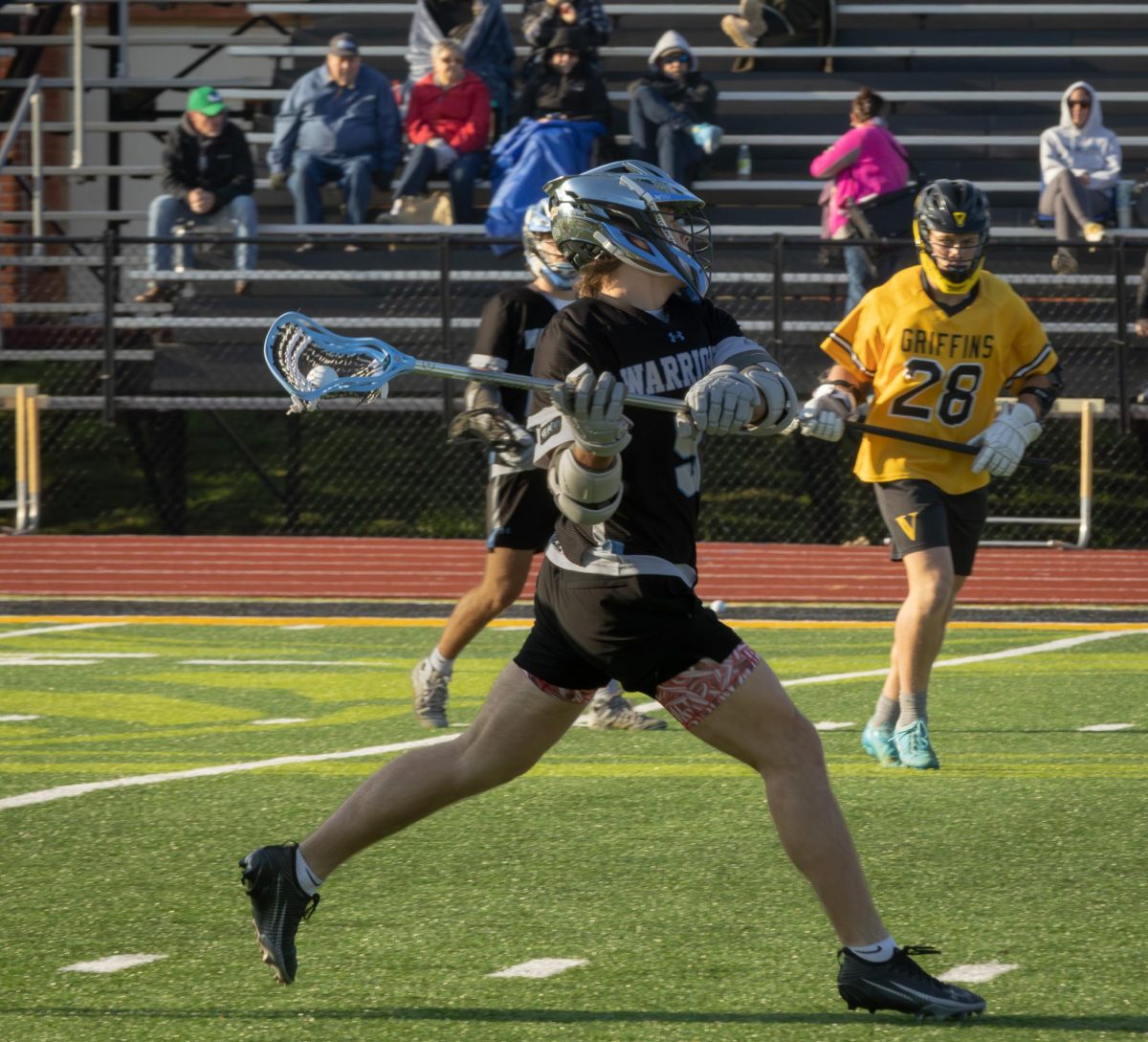 Junior Aj Stephens winds his stick back in hopes of scoring a goal at the game on April 7th. Stephens played in the middle position meaning he helps not only on defense but has scoring opportunities.