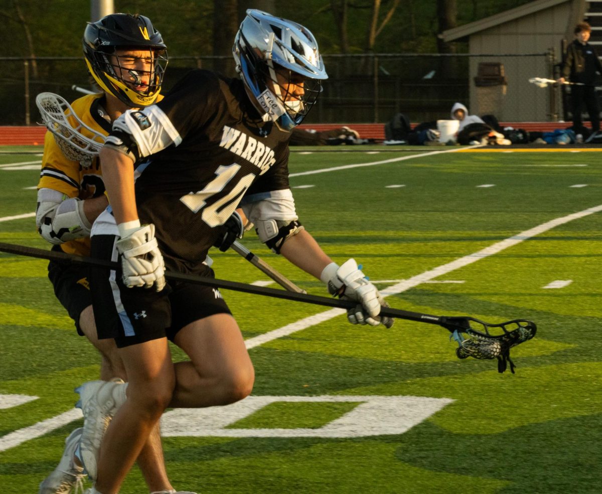 Getting pushed from the back at Vianney on April 7th, junior Matthew Grishman tries to run away from the other team. The opposite team's player got fouled and had to sit out for 2 minutes.