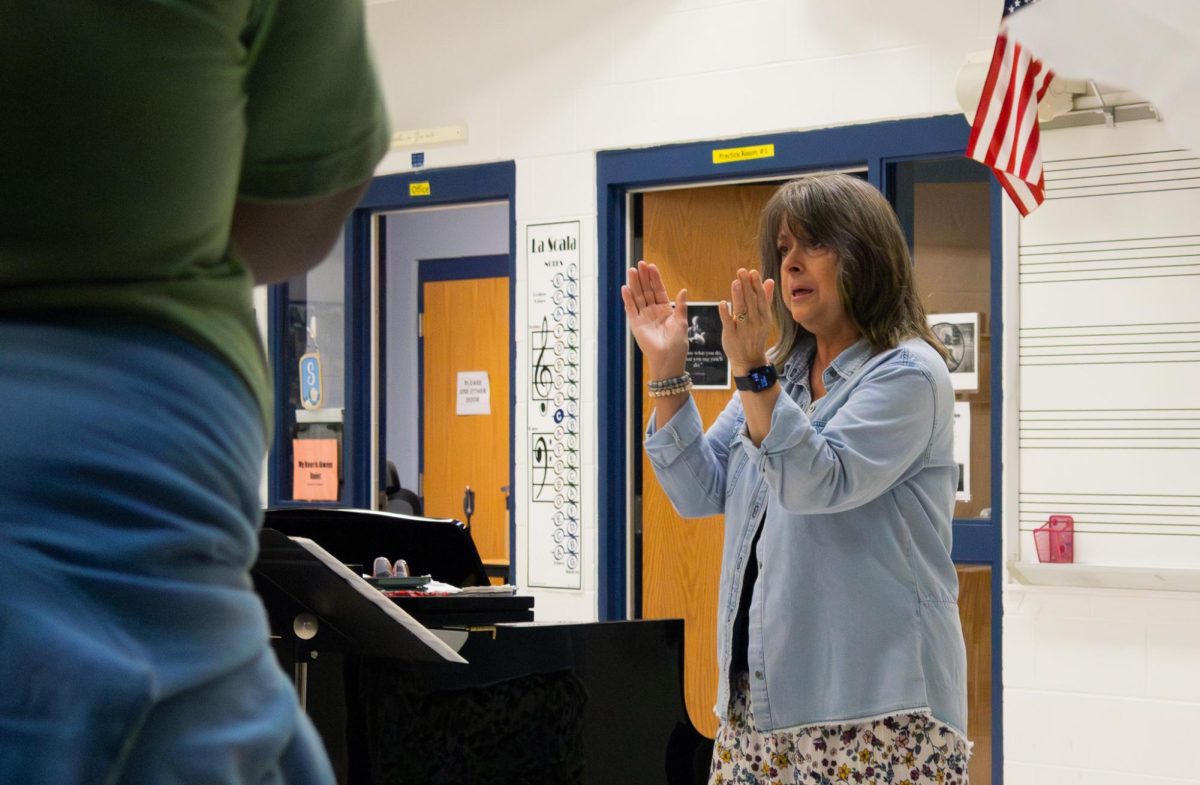 Francis Howell Central choir teacher, Mrs. Solverud directs her chamber choir on April 15. As she waved her hands the students sang in different tones for practice.
