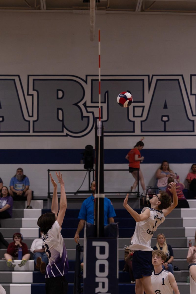 As an opposing player jumps to block, sophomore Louis Feiler prepares to spike the ball on April 23. A spike requires perfect timing, if they’re too early or late, the ball will be at a bad angle to land inside the court.