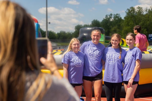 Lead advisor Laurie Fay holds one of the girls' phones and takes a picture. Fay then showed  them the picture and talked with them about Field Day.   
