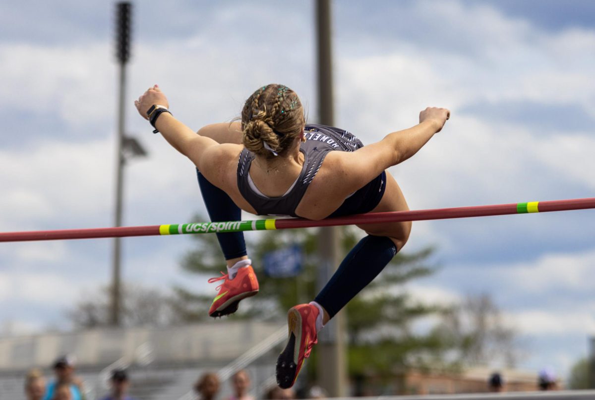 Senior Erin Getgood successfully jumps over the bar at the Todd Bizzell Memorial Relays on April 3. Getgood tosses herself in the air over the bar to make the height.

