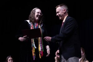 Senior Addie Law laughs with Mr. Trevor Wolfe as she accepts her award on May 7. The award she had received was the Coca-Cola award, and Law was the first Francis Howell Central student to ever receive this award.