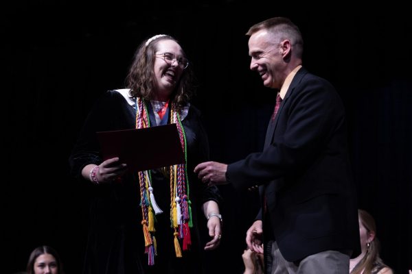 Senior Addie Law laughs with Mr. Trevor Wolfe as she accepts her award on May 7. The award she had received was the Coca-Cola award, and Law was the first Francis Howell Central student to ever receive this award.