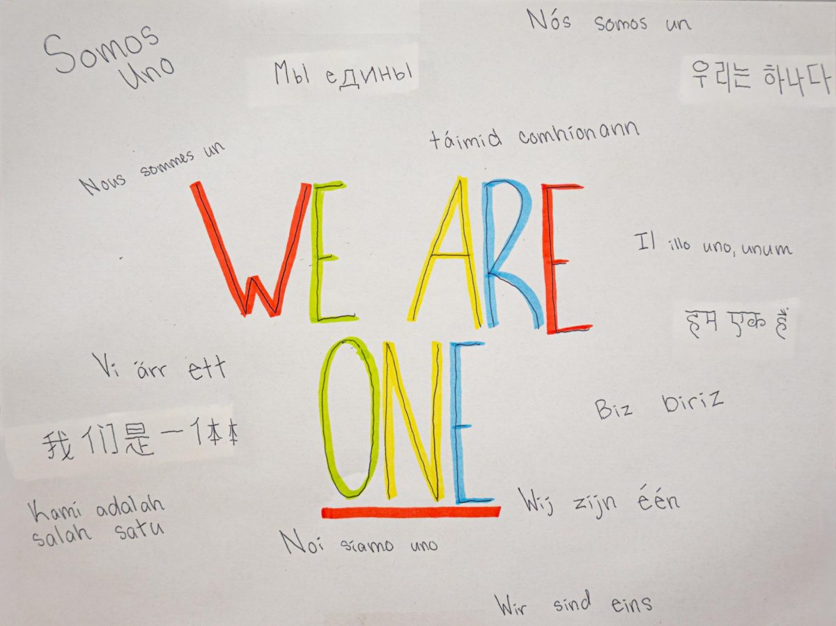 A paper translates "We Are One" into many different languages, showing a diverse set of students at FHC. Languages don't have to be a barrier, but rather a connecting force between cultures.