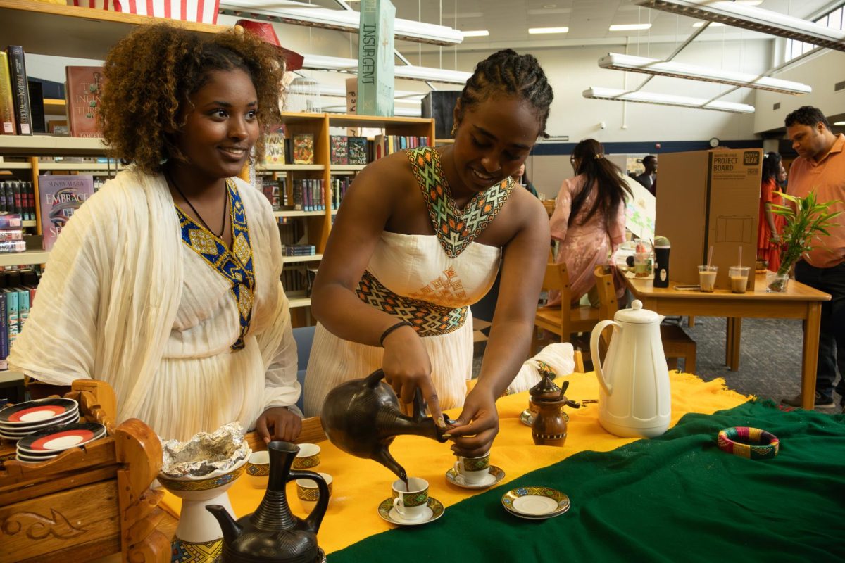  Pouring the coffee before the student took a sip of rich and exquisite bùena at the Ethiopia table at the culture fair. Liya Fikru had explained the culture of Ethiopia whilst her friend senior Nuwelin Dagne had poured the coffee in the scene for people to try from inside the jebena.
