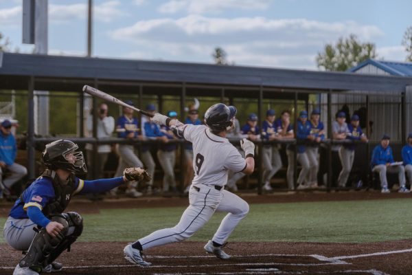 Senior Drew Wyss swings through a pitch during his at-bat on May 6. The bases were loaded, and thanks to Wyss, the Spartans scored another run.