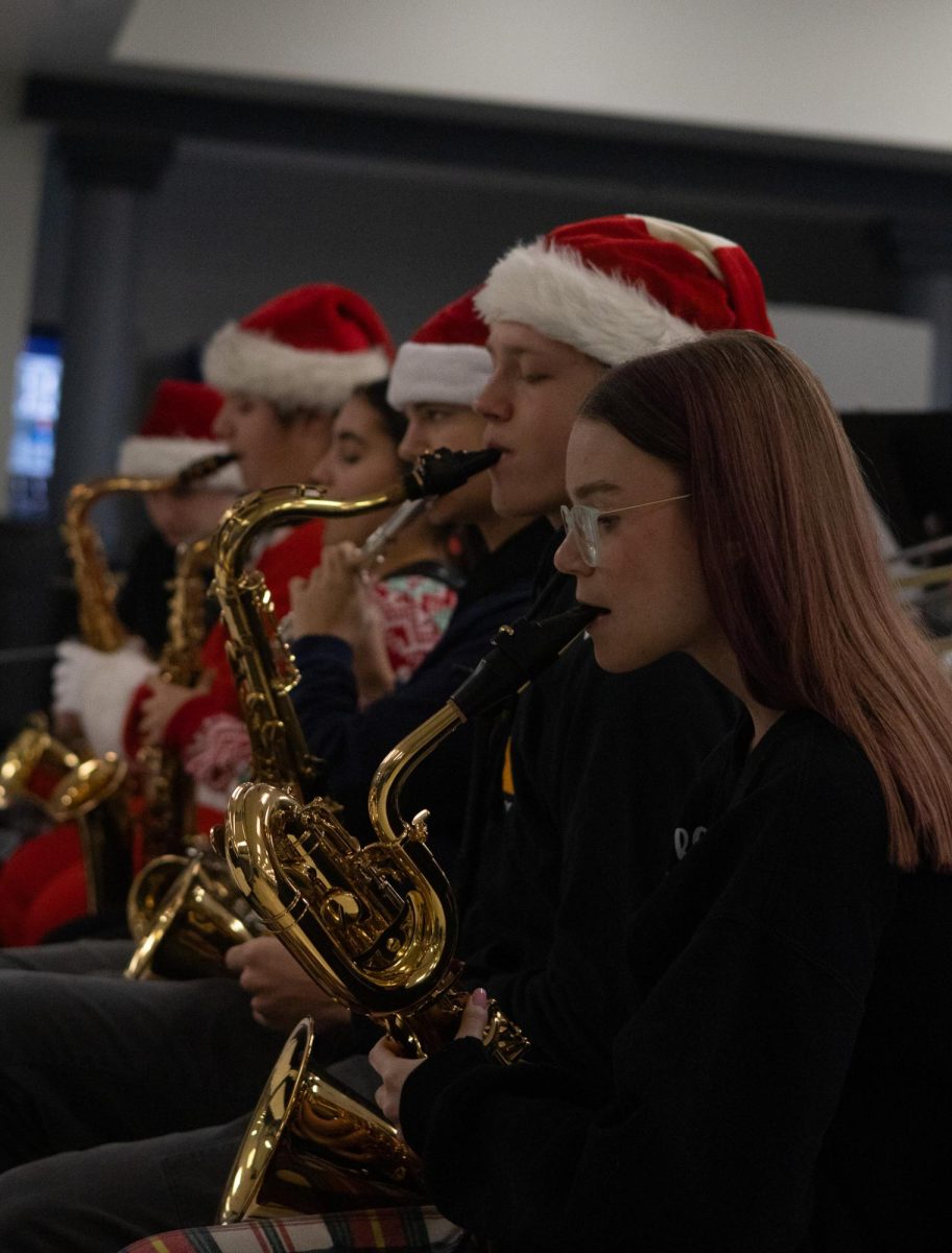 Jazz ensemble performing in-front of the school, in the cafeteria for students to observe and enjoy. These performances start students day on a positive note.