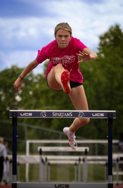 Senior hurdler Sam Painter jumps over a hurdle in practice. Hurdling is one of the many events offered in Track and Field. 
